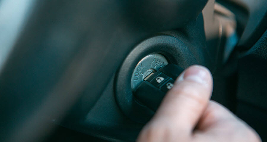 Hand of a man turning a Cadillac car key