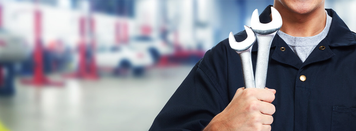 Close-up of a man holding a wrenches