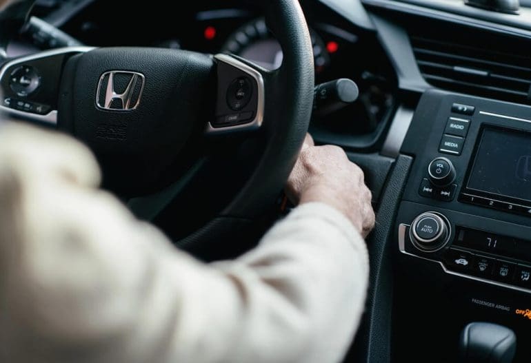 Hand of a man turning a honda car key