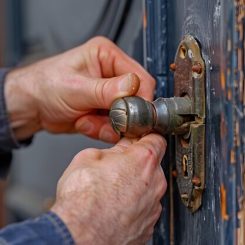 A locksmith performing lock maintenance by inspecting and adjusting a door lock to enhance security and ensure smooth operation.