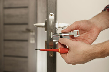 Lock Repair in Downtown Vancouver with locksmith performing rekey service on residential door lock.