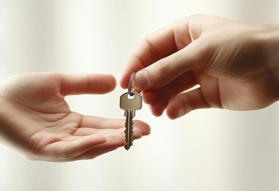 A hand on the right passes a master key to a hand on the left, set against a light, blurred background.