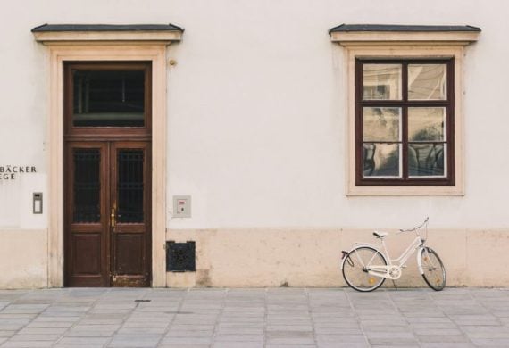 white cruiser bike beside white structure