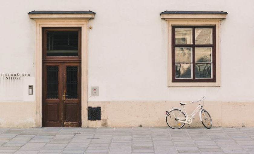 white cruiser bike beside white structure