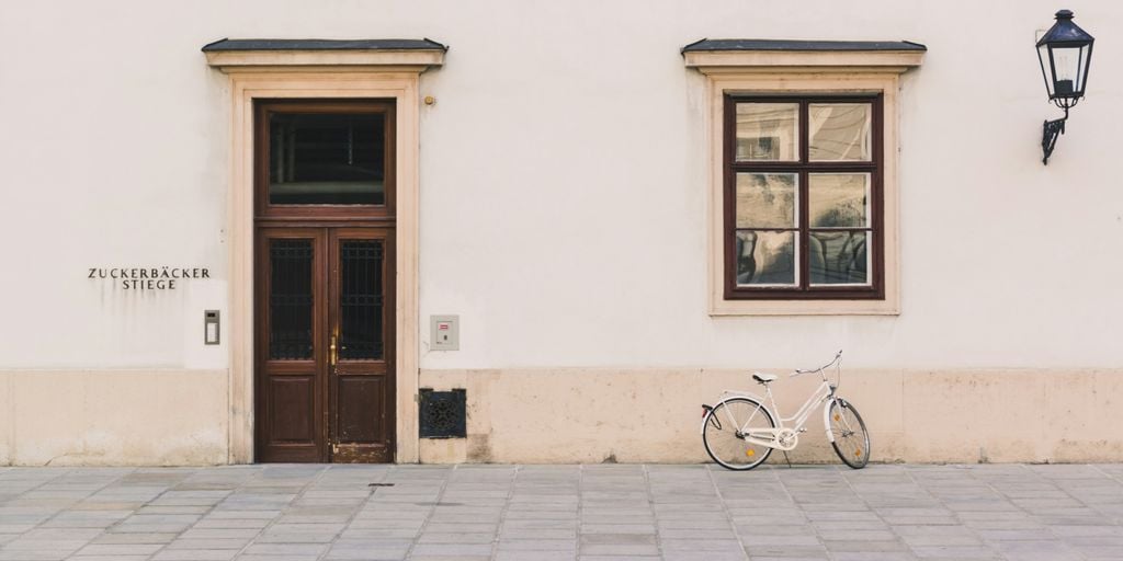 white cruiser bike beside white structure