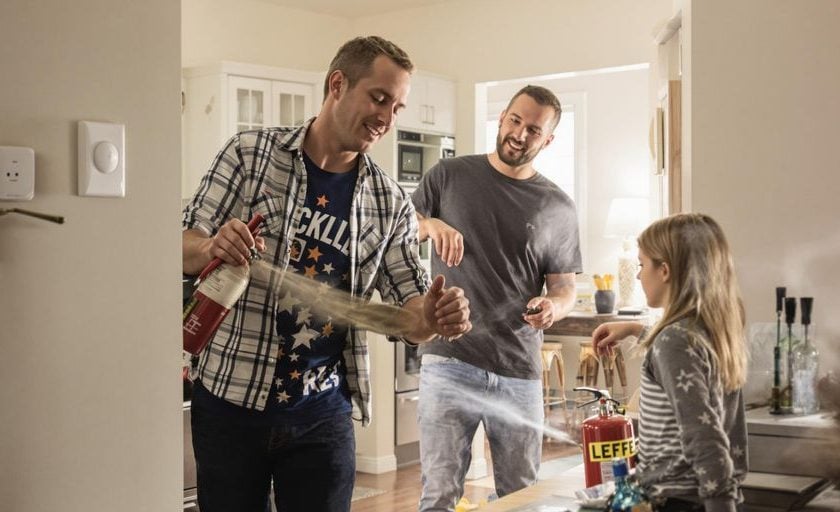 Family practicing fire safety drills at home.