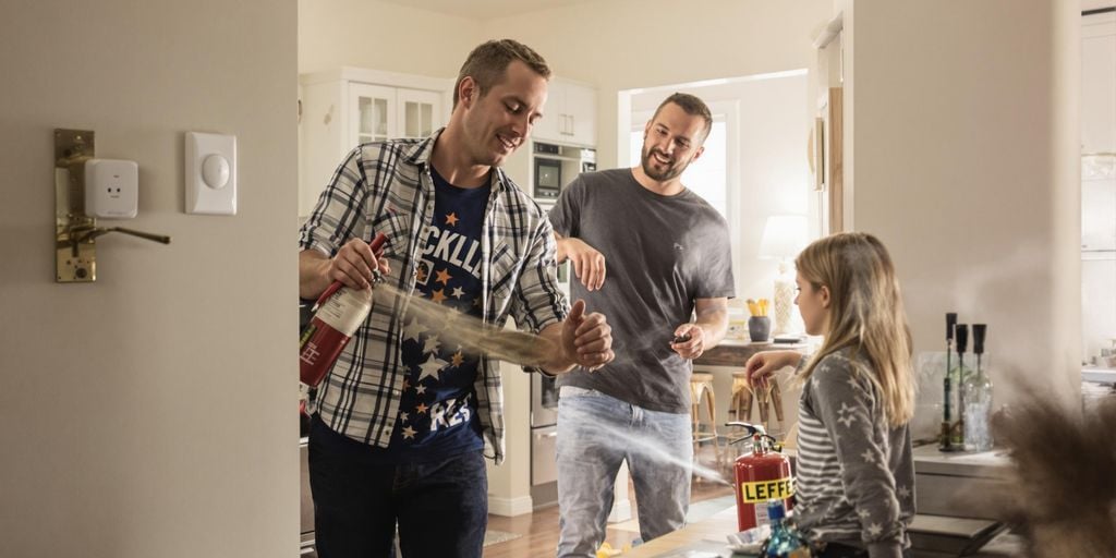 Family practicing fire safety drills at home.