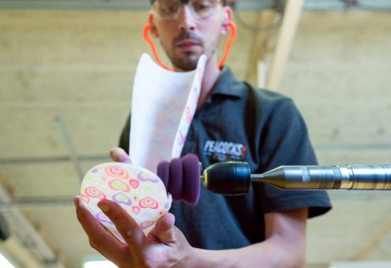 man in black polo shirt holding pink and white floral ceramic mug