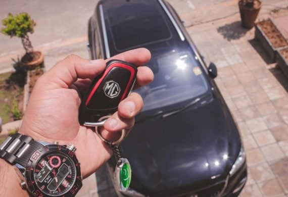 person holding black and red round digital watch