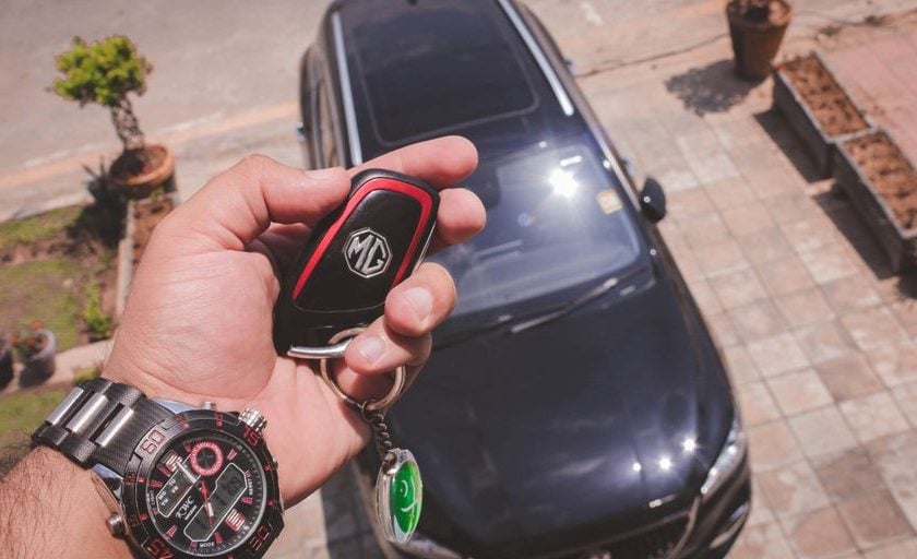 person holding black and red round digital watch