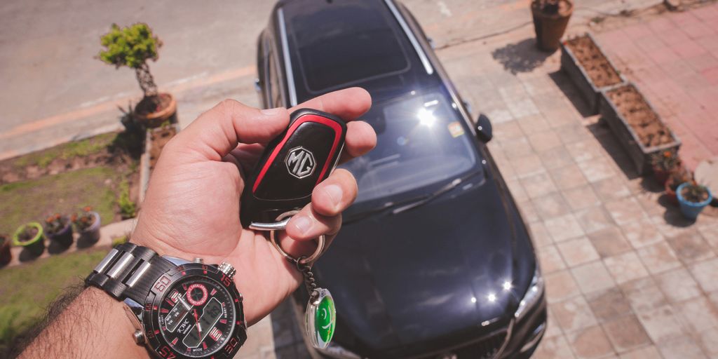 person holding black and red round digital watch